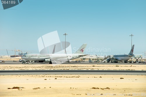 Image of Qatar airport strip with airplanes