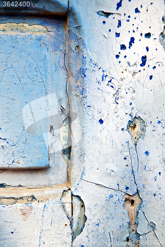 Image of dirty stripped  in the blue  door and rusty  