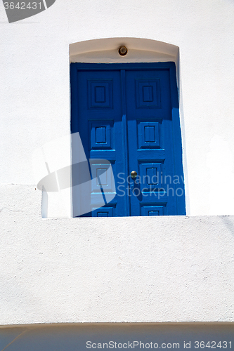 Image of blue door in village santorini greece    white wall