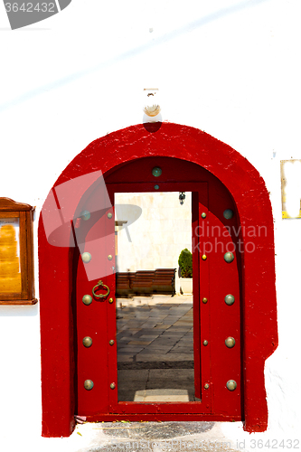 Image of white  red brown  door in   europe and    wall