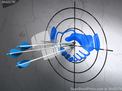 Image of Business concept: arrows in Handshake target on wall background
