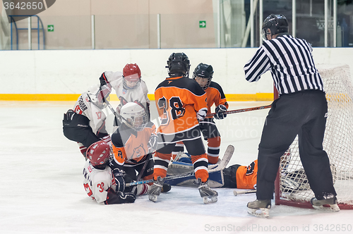 Image of Skirmish at gate in children ice-hockey