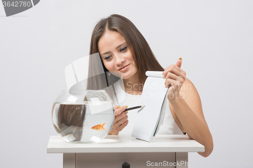 Image of She asks goldfish desire to the bookmark