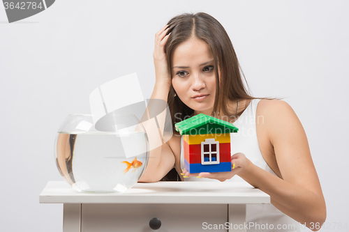 Image of A girl asks her house goldfish