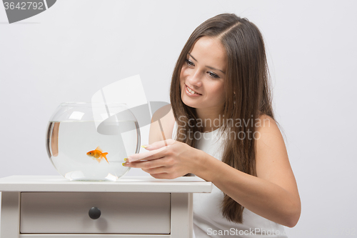 Image of The girl is very much like a goldfish in an aquarium