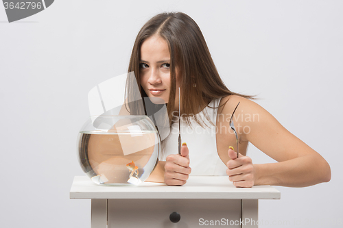 Image of Girl wants to eat a little goldfish