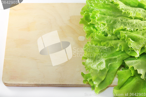 Image of Lettuce lying on wooden 