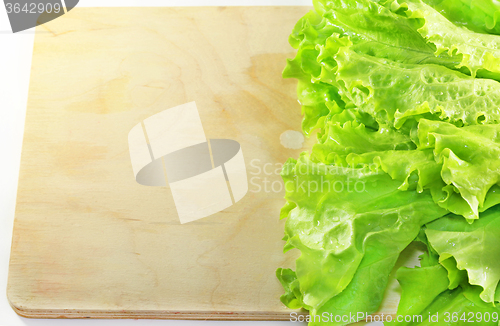 Image of Lettuce lying on wooden 