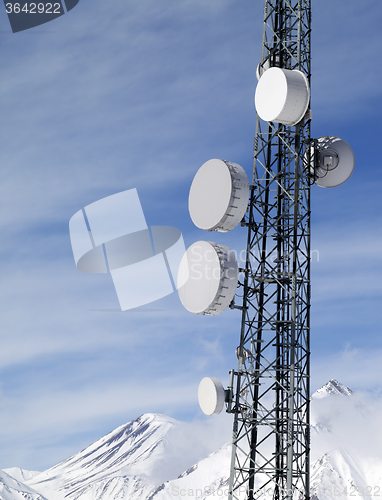 Image of Satellite dishes in snowy mountains at sun day
