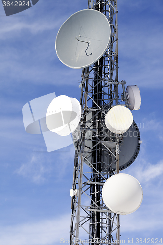 Image of Satellite dishes against blue sky