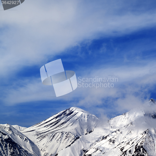Image of Winter snowy mountains and sky with clouds at nice day