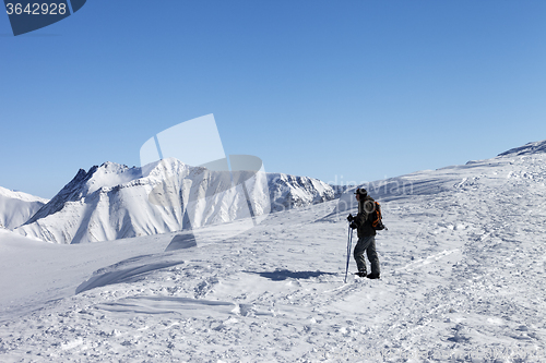 Image of Skier on top of ski slope at nice morning