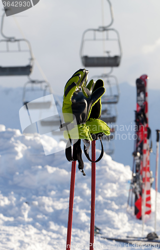 Image of Gloves on ski poles at ski resort 