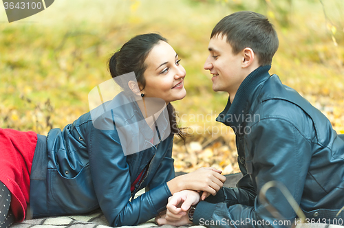 Image of Young romantic happy couple on autumn picnic