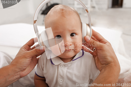 Image of baby with headphones listening to music