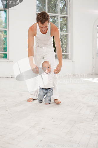 Image of young father with his nine months old son at home