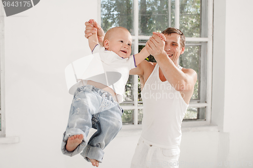 Image of young father with his nine months old son at home