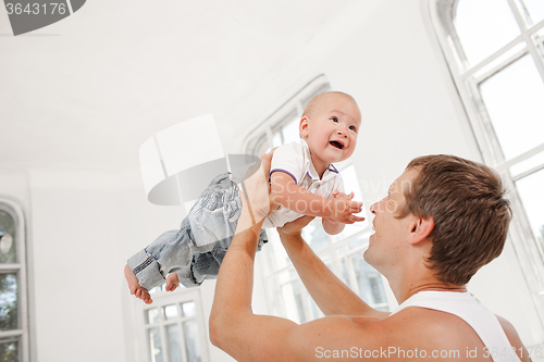 Image of young father with his nine months old son at home