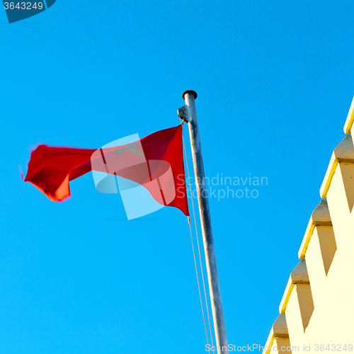 Image of tunisia  waving flag in the blue sky  colour and battlements  wa