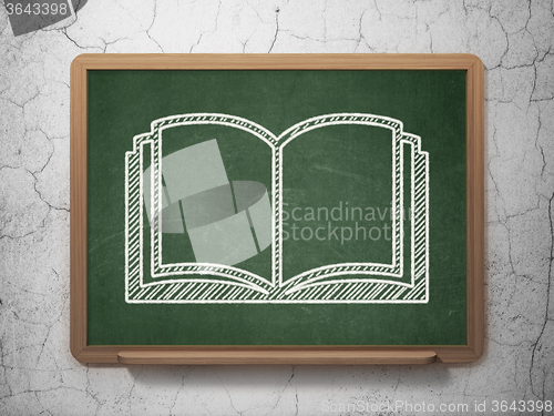 Image of Learning concept: Book on chalkboard background
