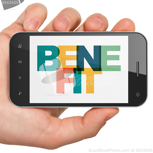 Image of Finance concept: Hand Holding Smartphone with Benefit on  display
