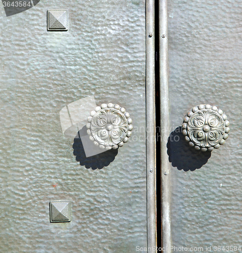 Image of  varese    knocker in a  door curch  closed  italy  sumirago