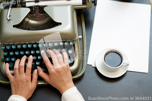 Image of closeup of coffee and hands writing