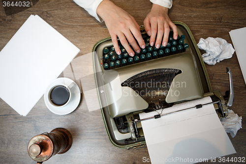 Image of Hands on typing machine