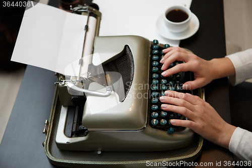 Image of Hands writing on typewriter