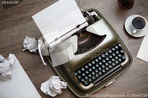 Image of Old typewriter, paper, coffee