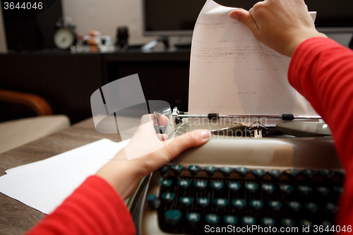 Image of woman working on typewriter