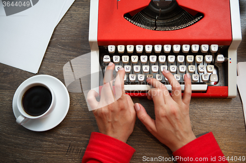 Image of Hands on typing machine