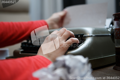 Image of woman working on typewriter