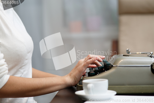 Image of Hands writing on typewriter