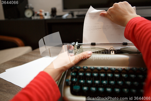 Image of woman working on typewriter