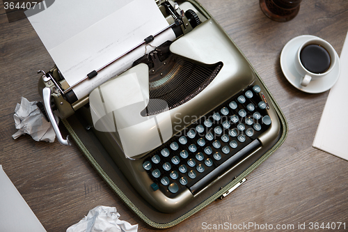 Image of Old typewriter, paper, coffee