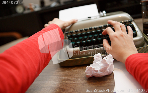 Image of woman working on typewriter