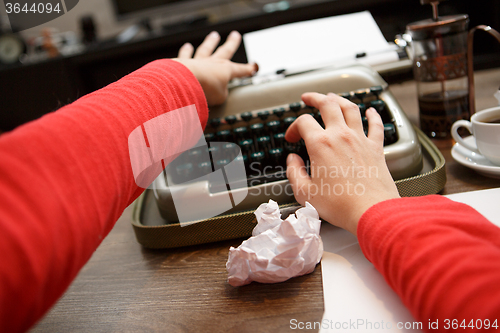 Image of woman working on typewriter