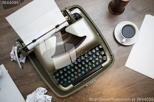 Image of Old typewriter, paper, coffee