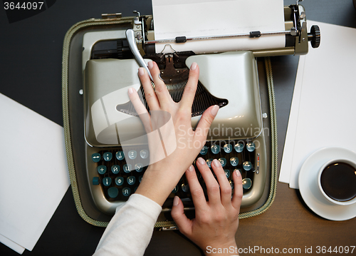 Image of closeup of coffee and hands writing