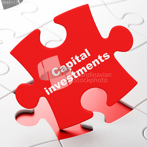 Image of Currency concept: Capital Investments on puzzle background