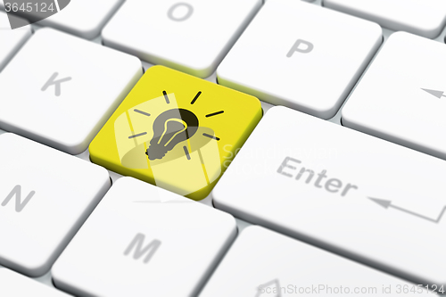 Image of Business concept: Light Bulb on computer keyboard background