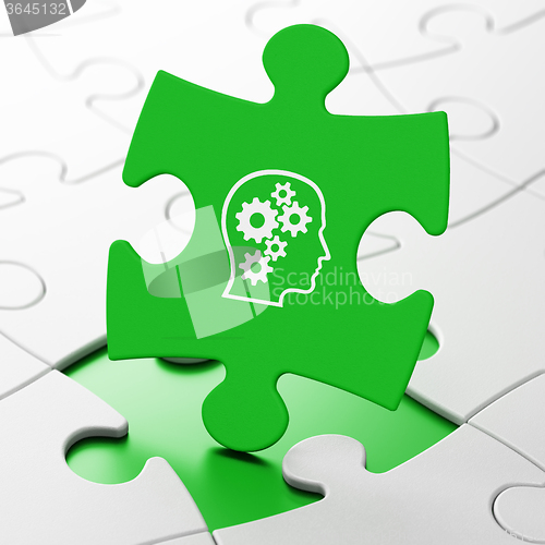 Image of Information concept: Head With Gears on puzzle background