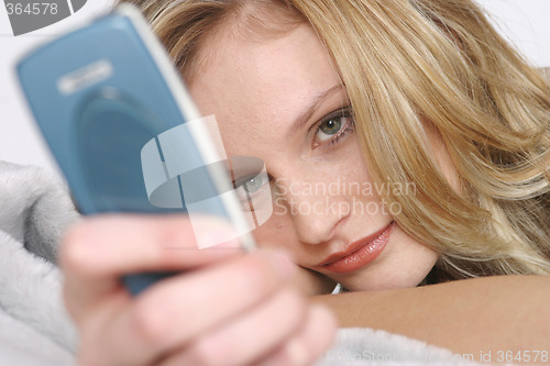 Image of Young woman with mobile phone