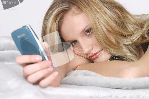 Image of Young woman with mobile phone