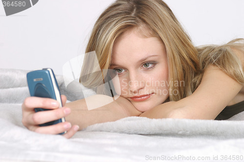 Image of Young woman with mobile phone
