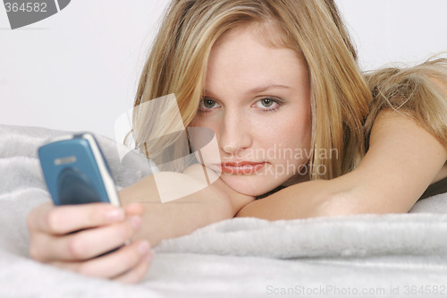 Image of Young woman with mobile phone
