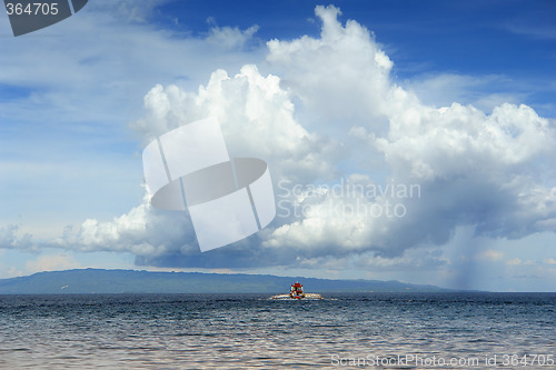 Image of Tropical cloudscape with boat