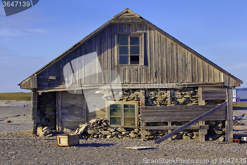 Image of Three-layered house of old polar station on shore of Barents sea. Cape White Nose, Yugorsky Peninsula, Destroyed by hurricane and powerful storm