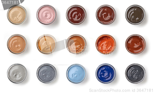 Image of different color shoe grease jars